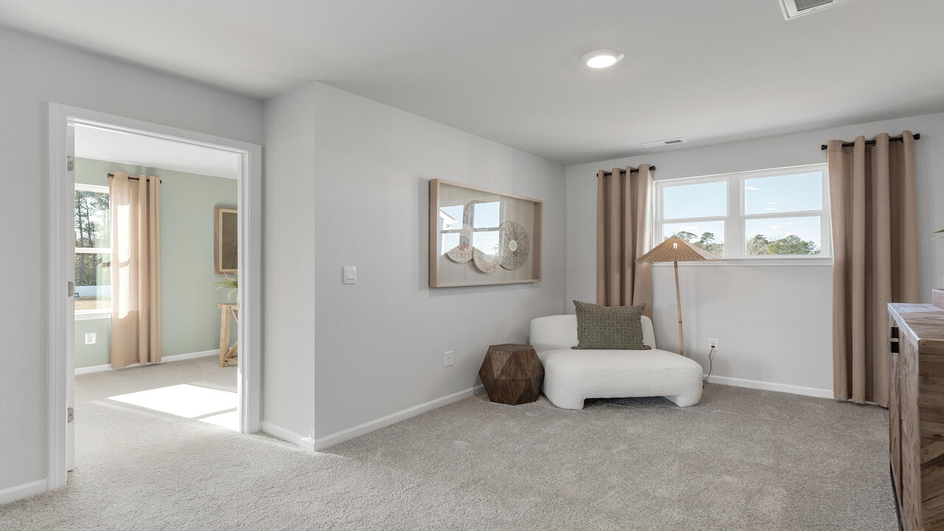 Versatile loft in the Norman floor plan at Old Bailey by D.R. Horton featuring flexible living space for a media room, playroom, home office, or lounge area.