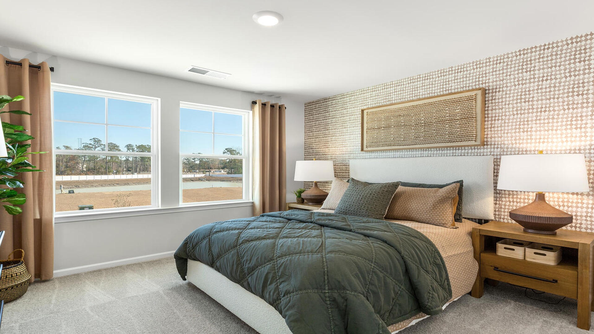 Guest bedroom in the Norman home ideal for family members, visitors, or a home office setup.
