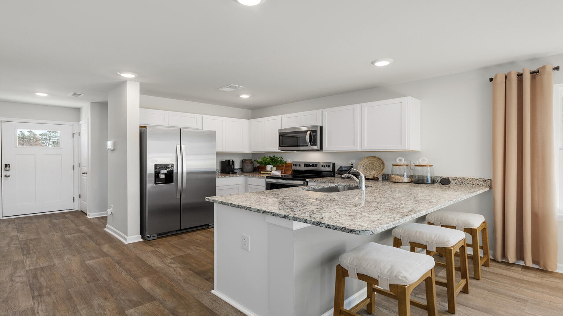 Modern kitchen in the Norman home at Old Bailey showcasing open-concept design, stylish finishes, and ample prep space.