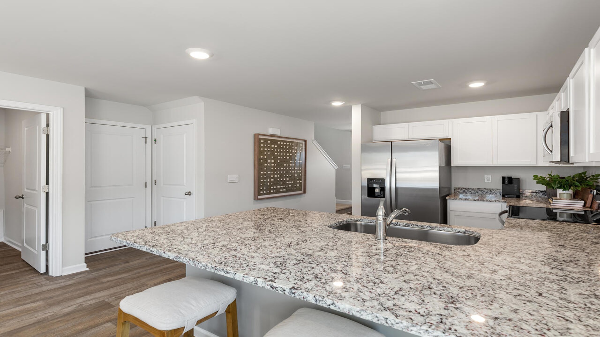 Open-concept kitchen in the Norman home at Old Bailey designed for entertaining with modern finishes and seamless flow to the dining and living areas.