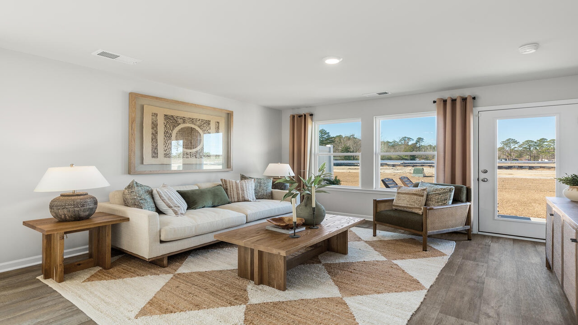 Open-concept living room in the Norman floor plan at Old Bailey featuring spacious gathering areas, natural light, and modern finishes.