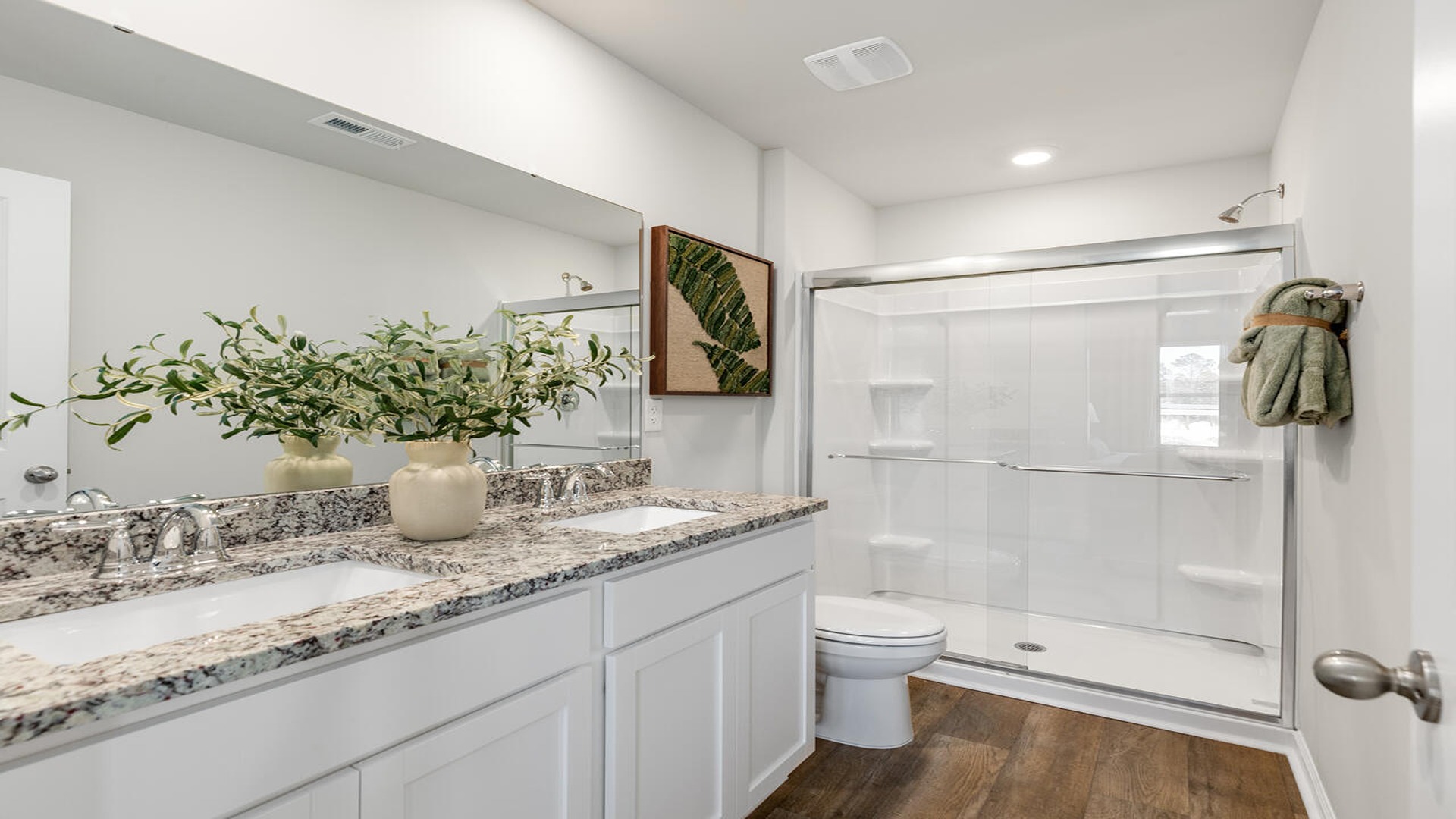 Luxury primary bathroom in the Norman floor plan at Old Bailey featuring dual vanities, a walk-in shower, and contemporary finishes.