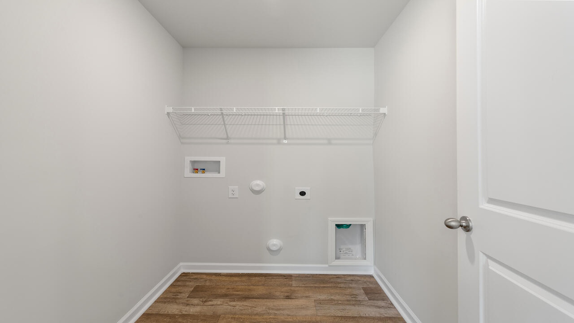Convenient laundry room in the Norman floor plan featuring dedicated workspace, storage options, and everyday functionality.