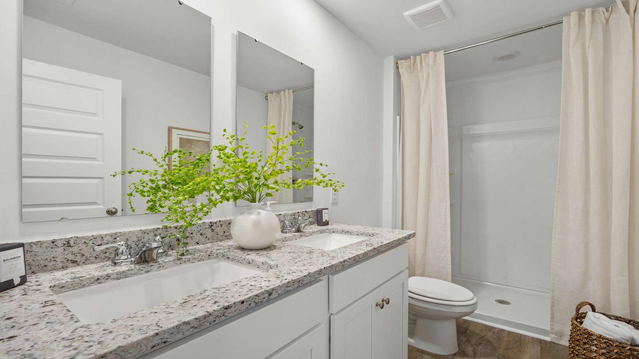 Primary bathroom in the Norman townhome featuring dual-sink vanity, modern fixtures, and spacious design