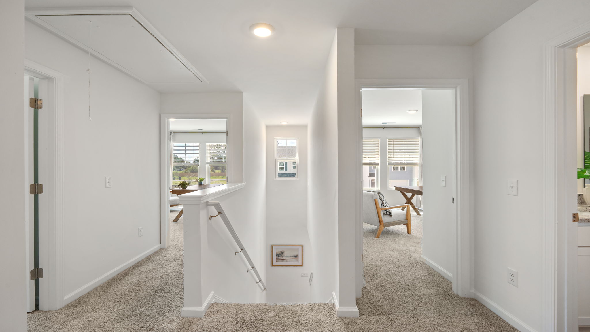 Second-floor hallway in the Norman townhome providing access to bedrooms, loft, and additional living spaces