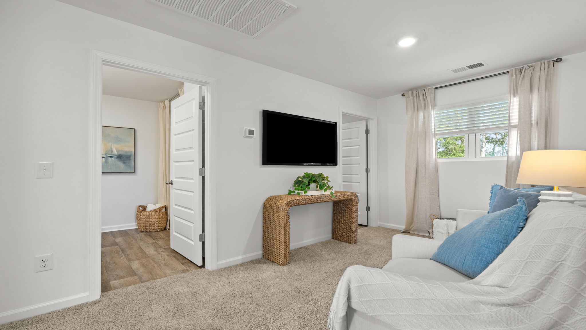 Versatile loft area in the Norman townhome ideal for a media room, study space, or additional living area