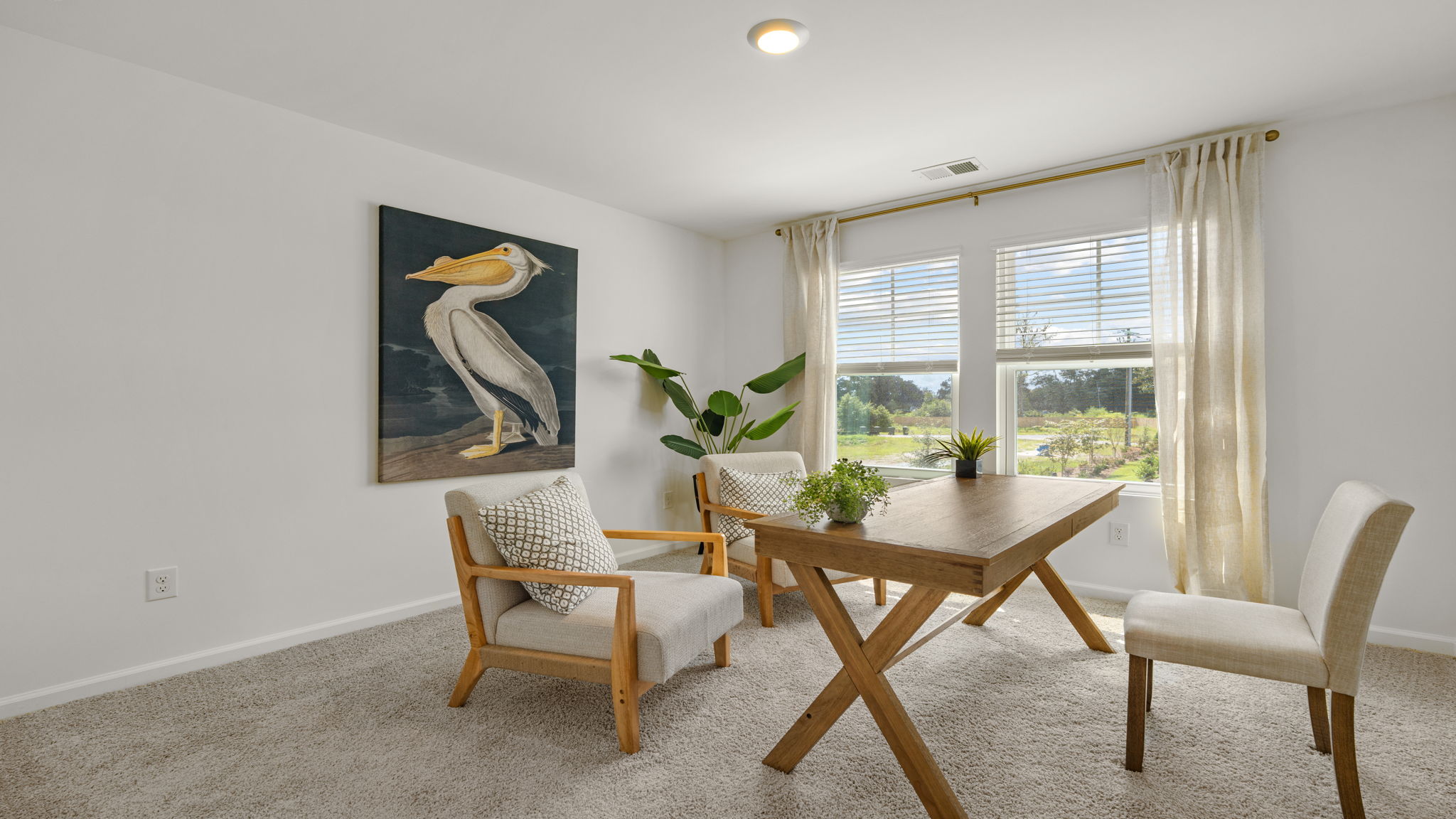 Multi-purpose room in the Norman townhome offering flexibility for work, hobbies, or overnight guests