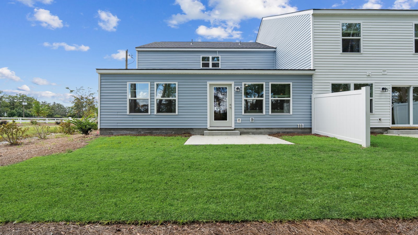 Backyard view of the Norman townhome highlighting outdoor living space and rear elevation design