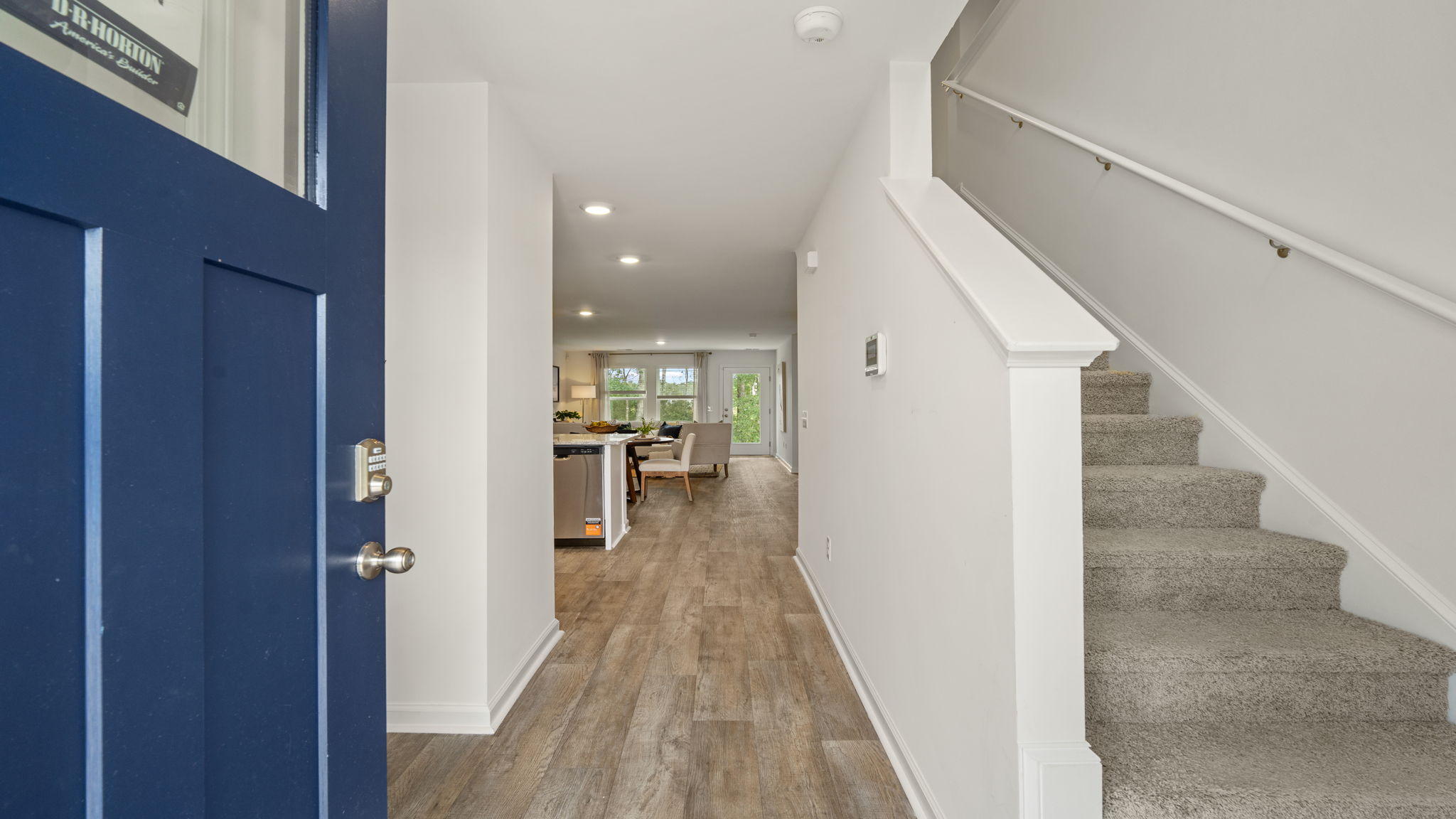 Welcoming foyer entry in the Norman townhome with stairway access and open main-level floor plan