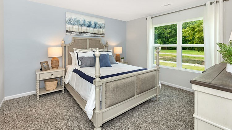 Primary bedroom decorated with a bed and a dresser