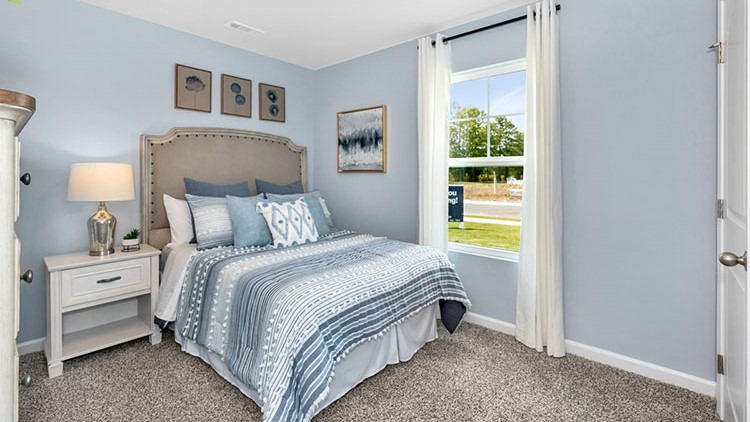 Guest bedroom decorated with a bed and side table