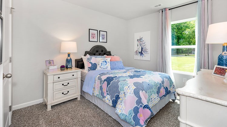 Guest bedroom decorated with a bed and side table