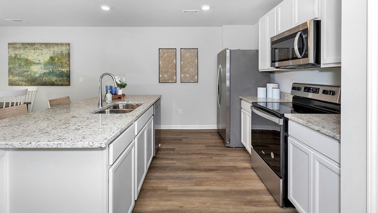 Kitchen walkway with counters on both sides
