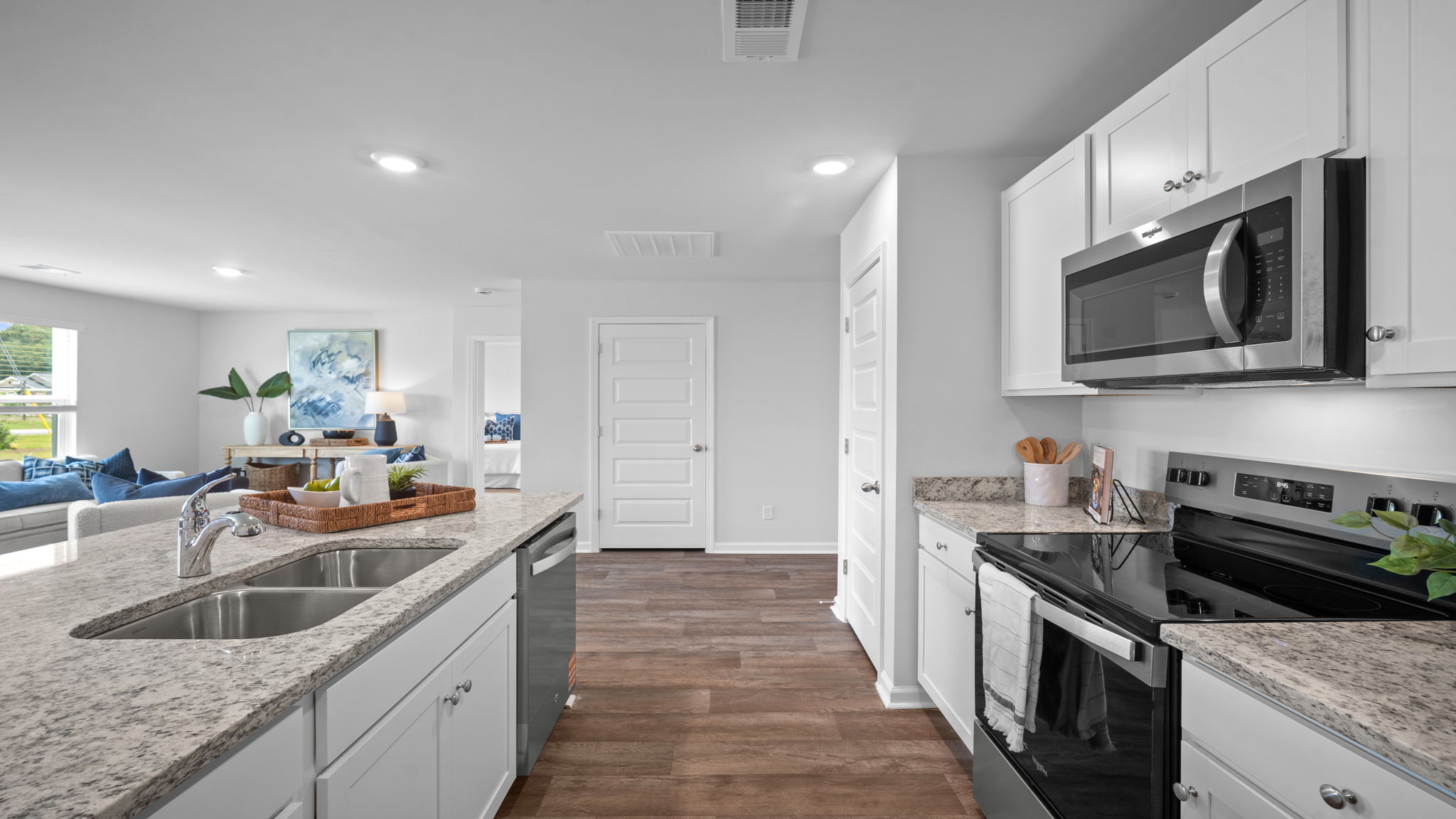 Spacious kitchen with stainless steel appliances, abundant cabinetry, large center island, and walk-in pantry in the Freeport by D.R. Horton.