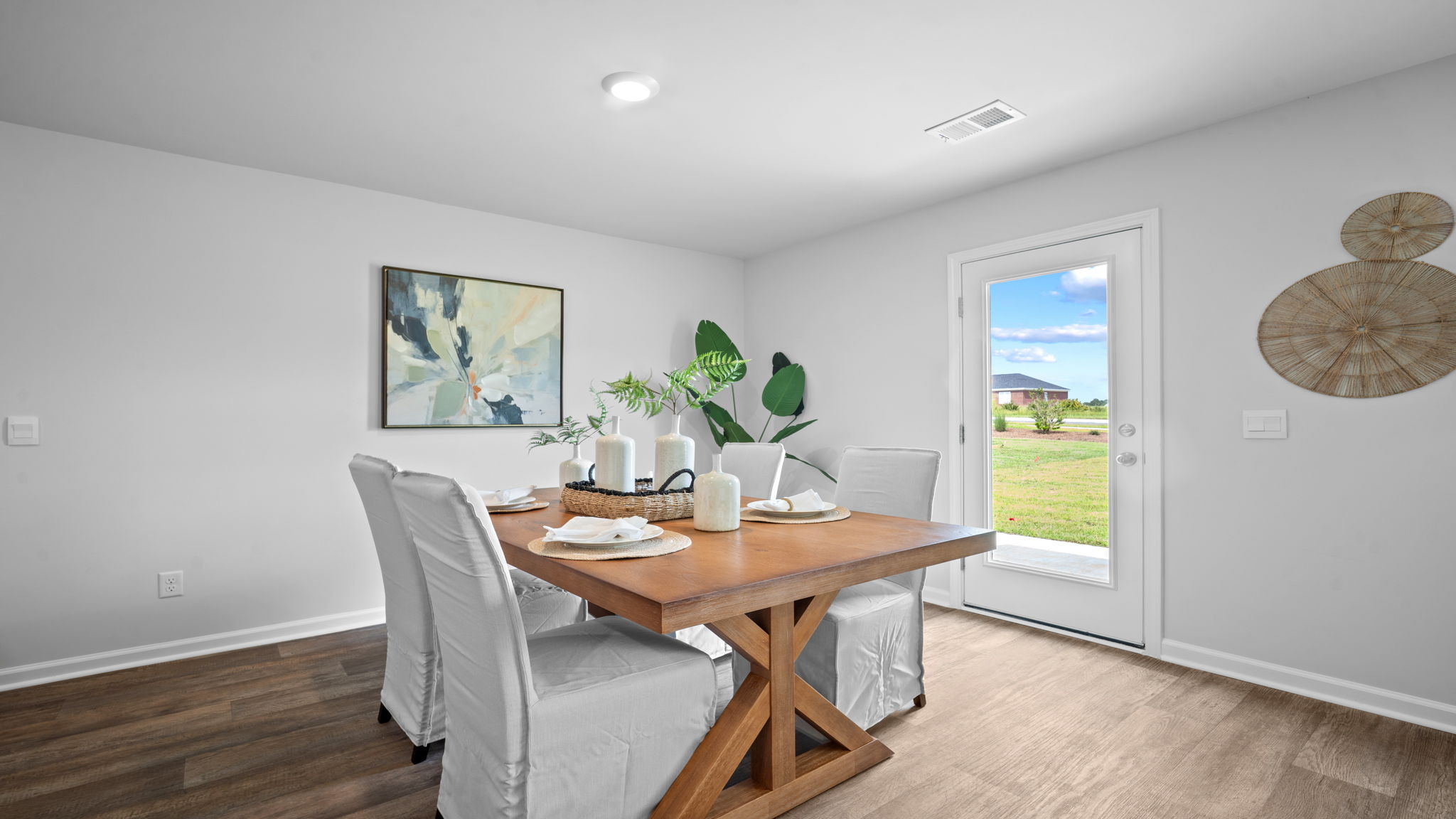 Dining area in the Freeport by D.R. Horton offering open flow to the kitchen and family room