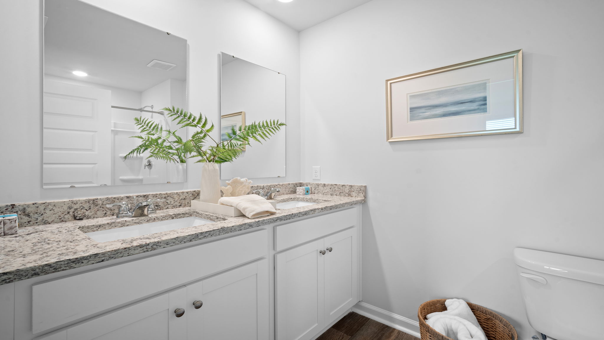 Primary bathroom in the D.R. Horton Freeport featuring dual sinks and modern finishes