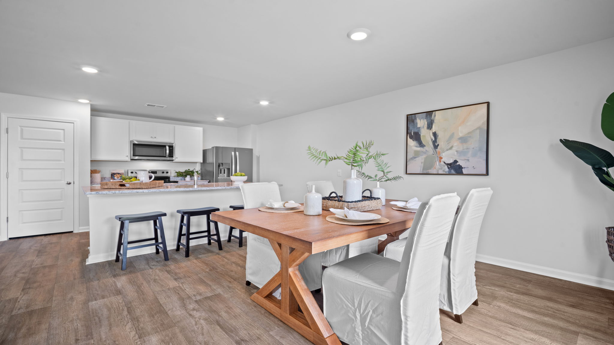 Open dining area adjacent to the kitchen and family room, offering a functional layout for casual dining and special occasions.