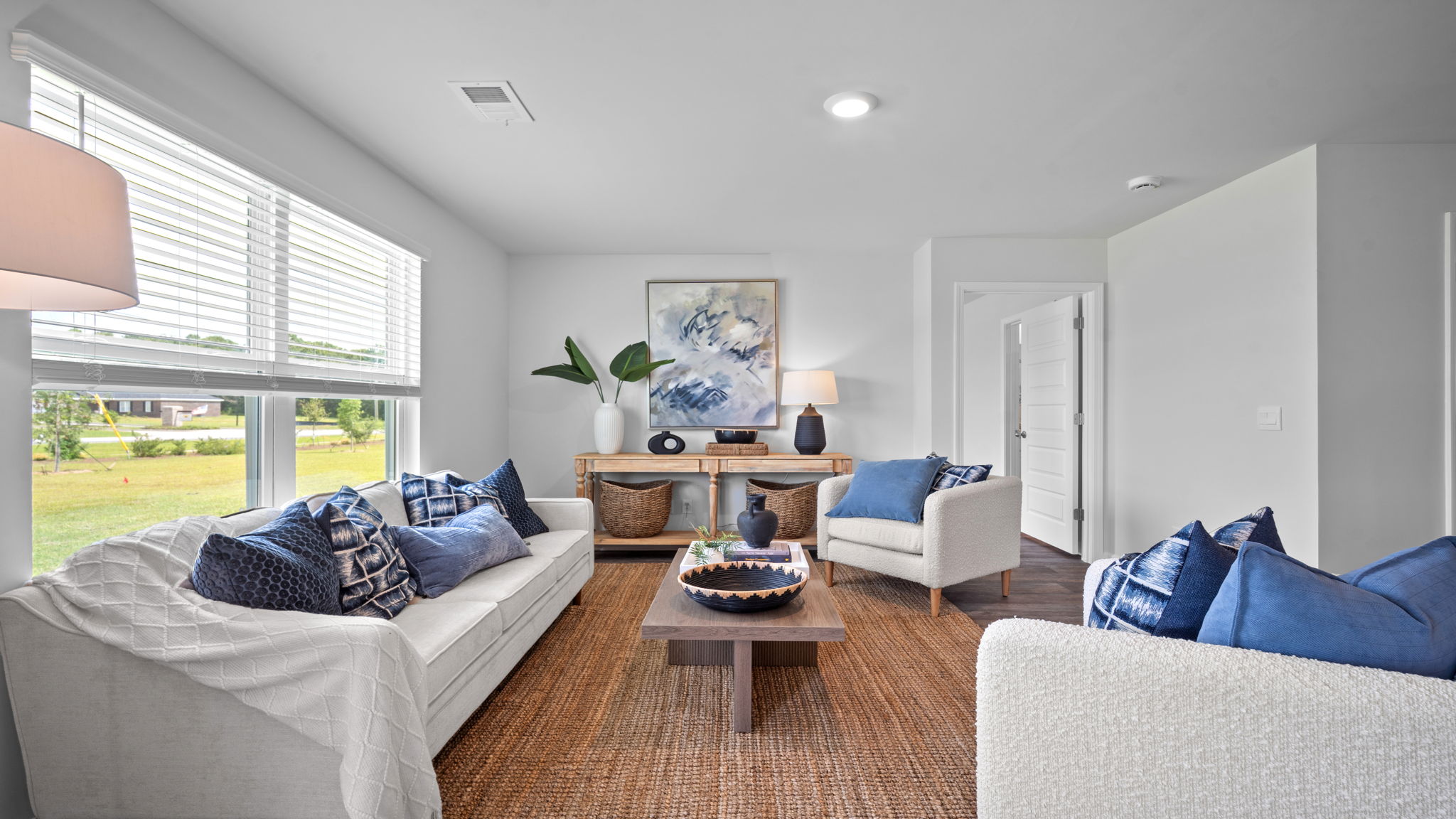 Spacious living area with large windows for natural lighting.