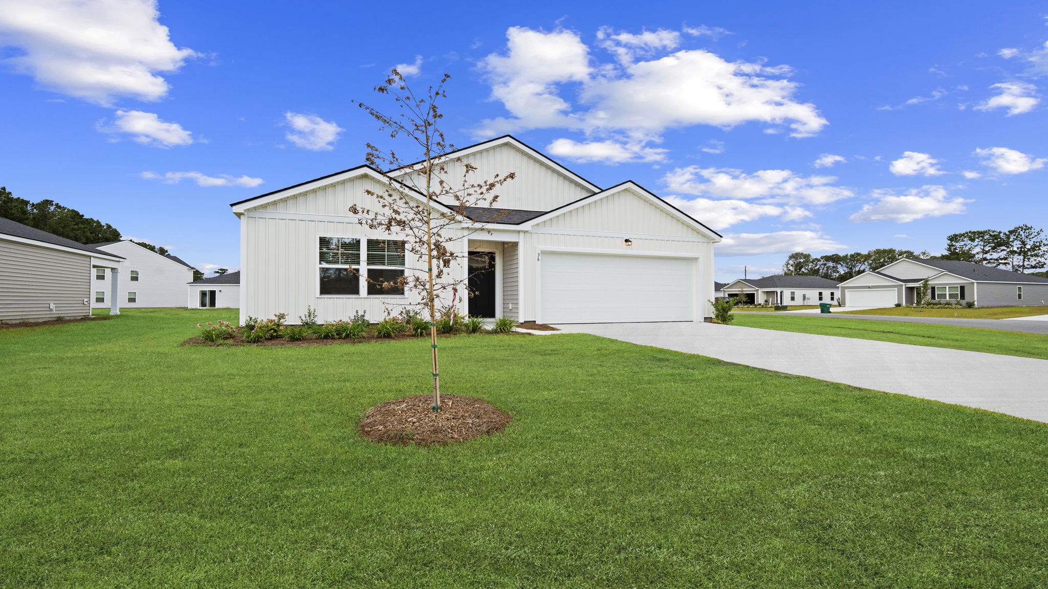 Front exterior showcasing modern architecture, spacious homesite, and inviting curb appeal.