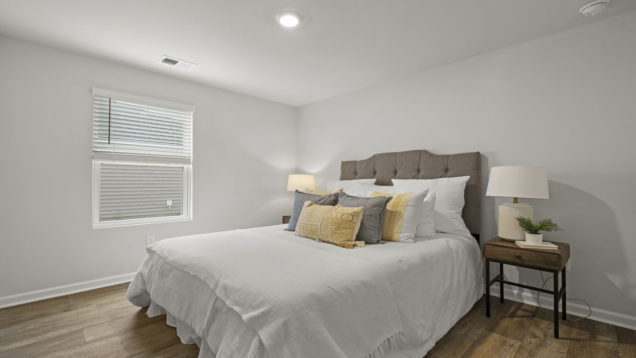 Guest bedroom featuring natural light, ample wall space, and modern finishes.
