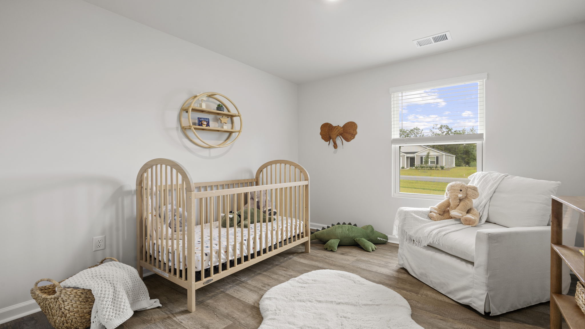 Versatile bedroom suitable for nursery, guest room, or home office with abundant natural light.