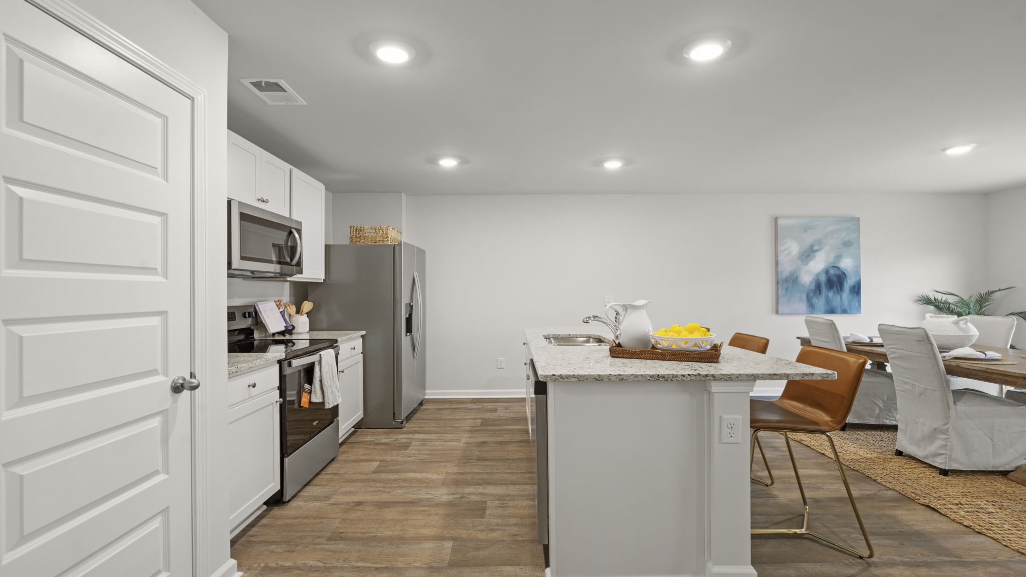 Functional eat-in kitchen with center island, granite countertops, and open-concept layout.