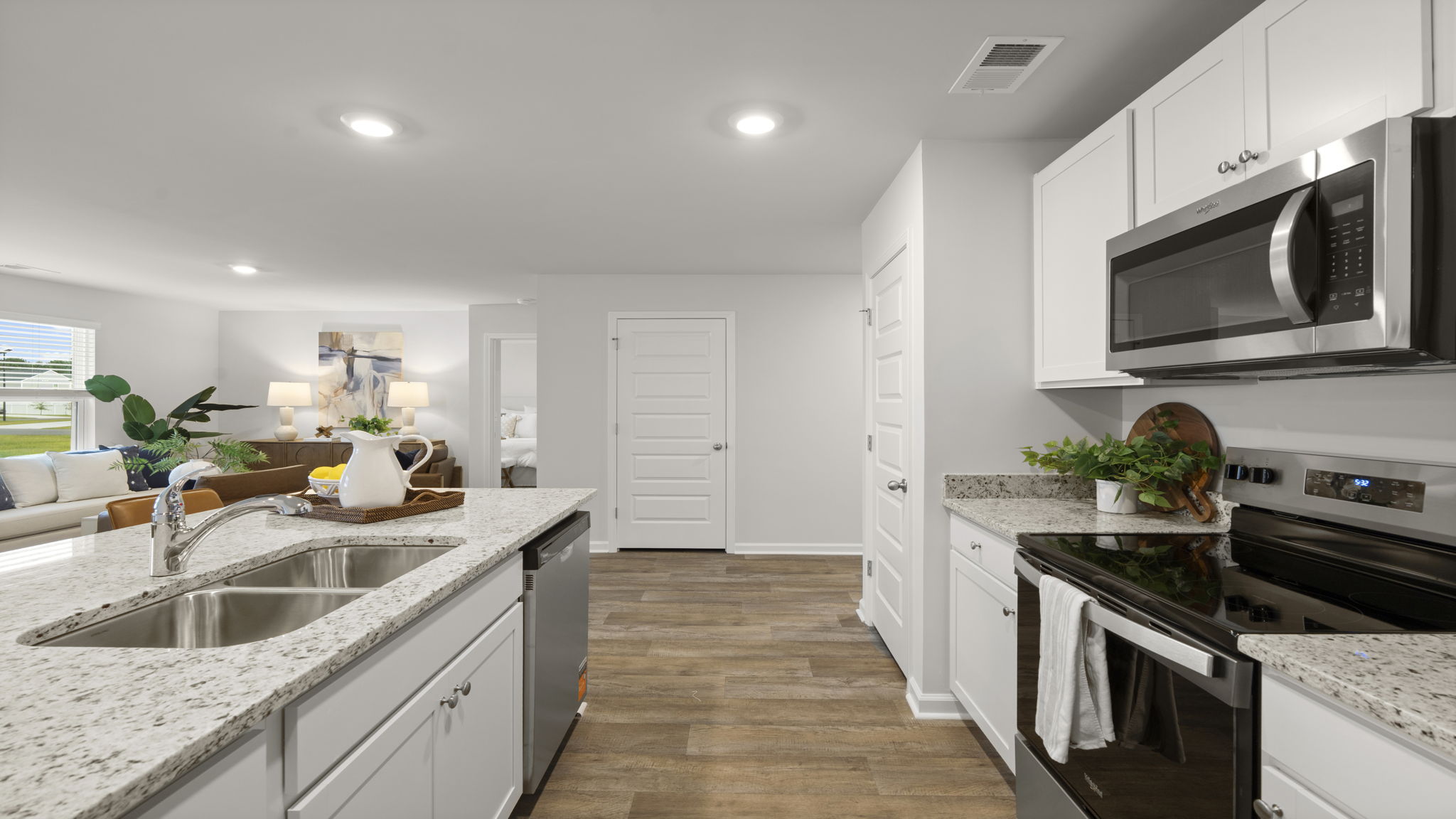 Modern kitchen with granite countertops, stainless steel appliances, abundant cabinetry, and functional workspace.