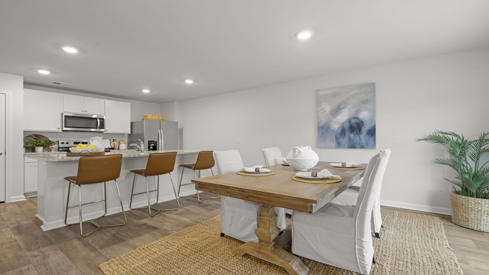 Open dining area overlooking kitchen and family room, creating an ideal space for gatherings and entertaining.