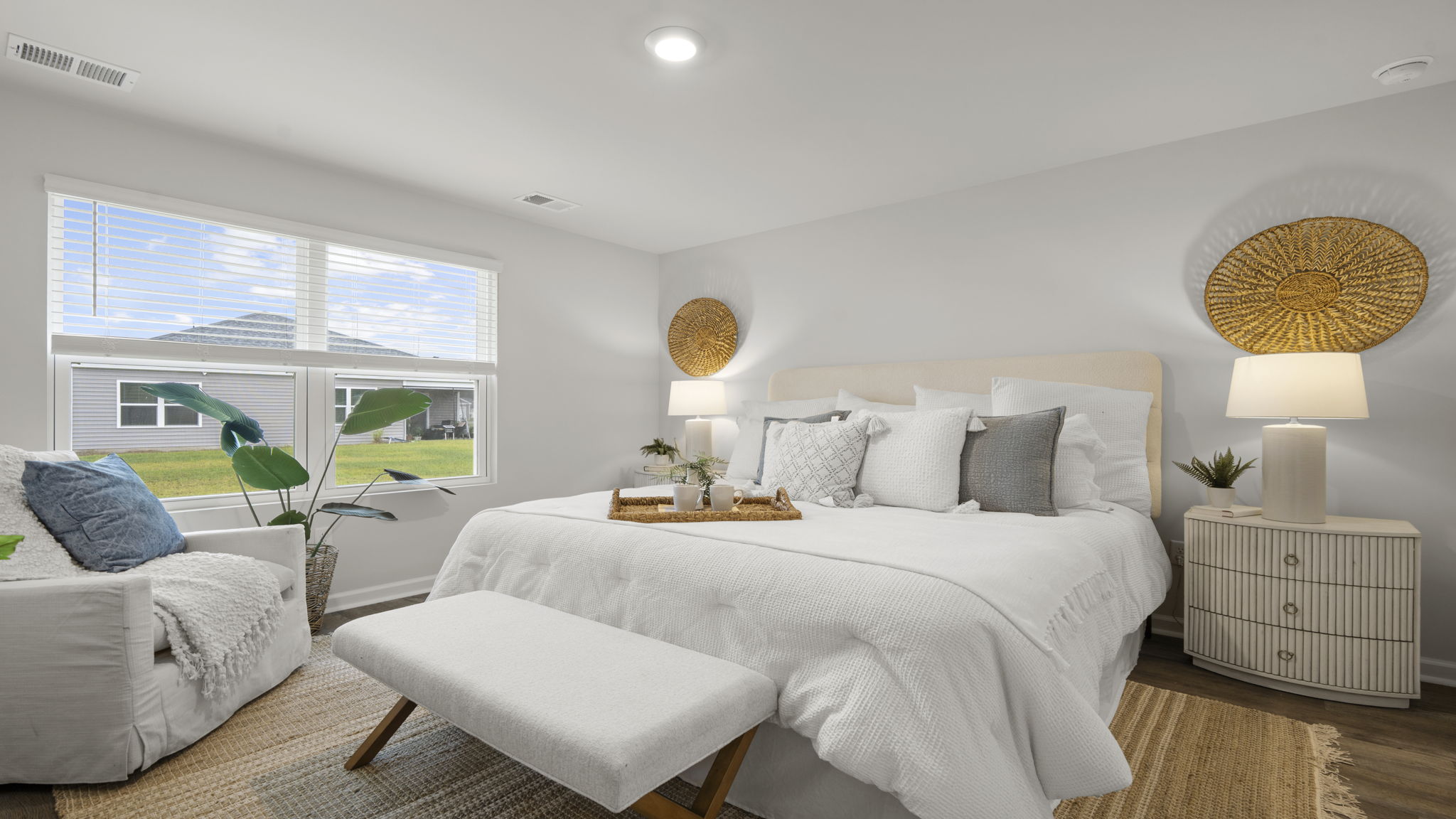Spacious primary bedroom with large windows, abundant natural light, and private ensuite bath.