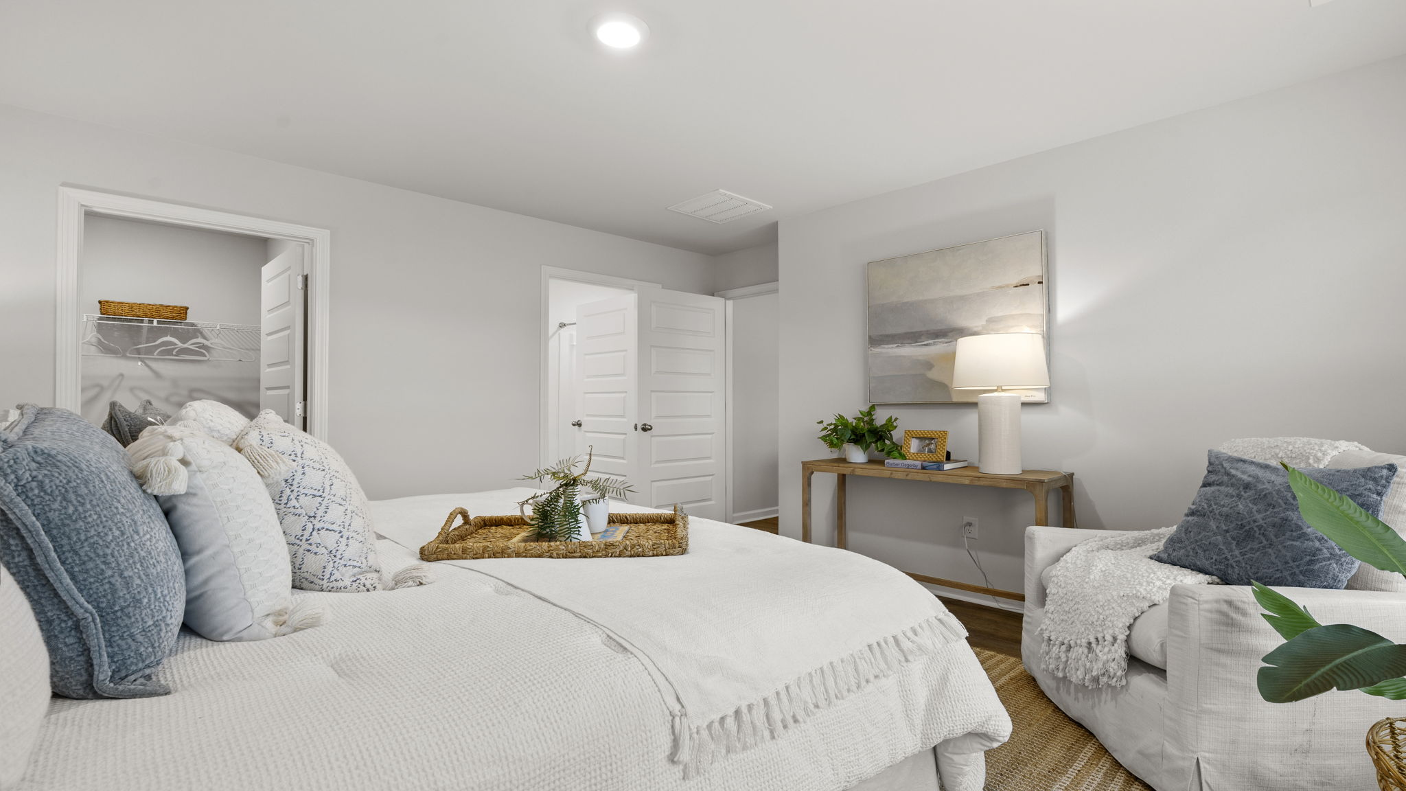 Comfortable primary suite with neutral finishes, bright windows, and convenient access to ensuite bathroom.