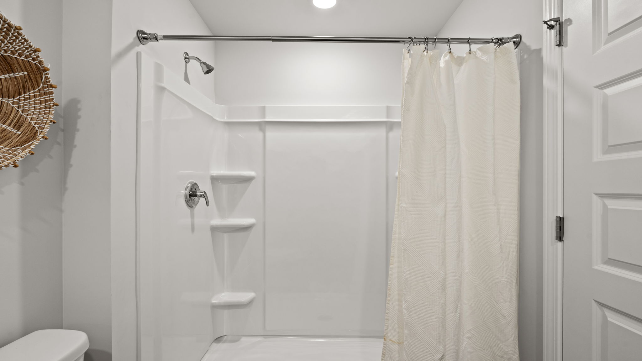Primary bathroom with walk-in shower, spacious layout, and contemporary finishes.