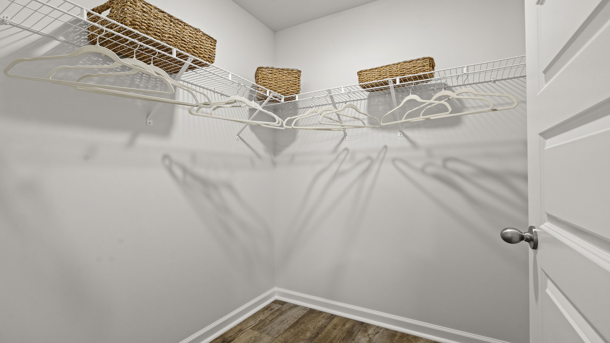 Large walk-in closet with built-in shelving and ample storage space.