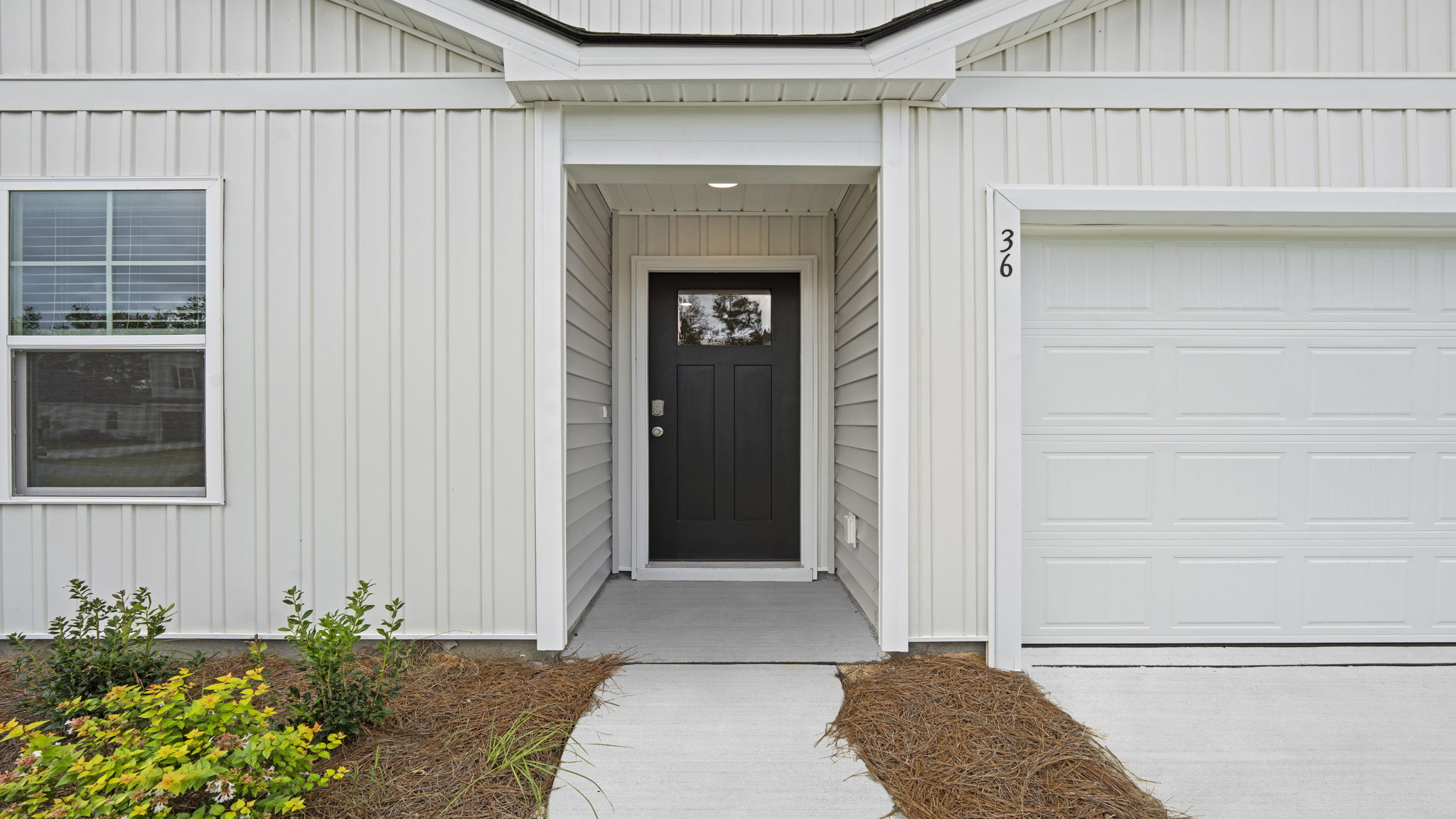 Covered front entry with decorative details and welcoming curb appeal.
