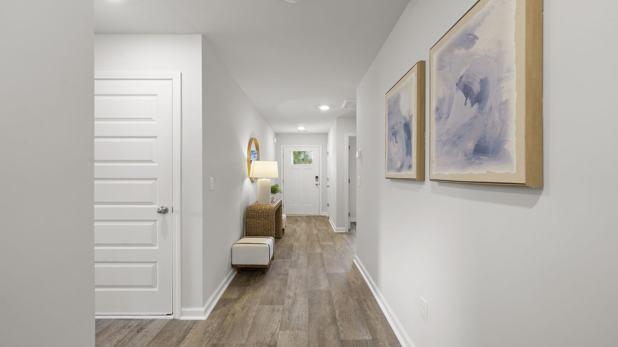 Bright entry hallway showcasing open floor plan and modern interior finishes.