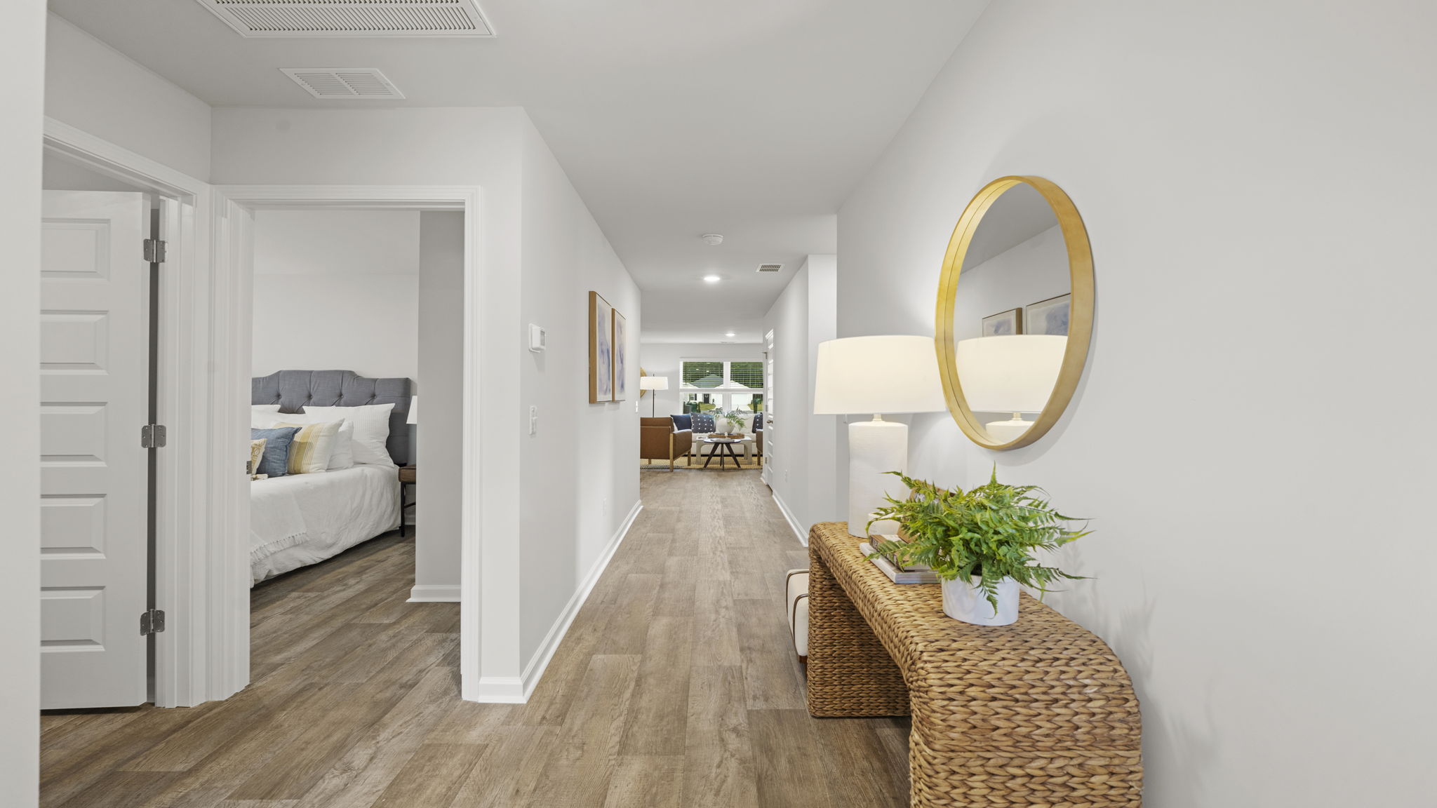 Welcoming interior hallway leading to bedrooms and main living areas with luxury vinyl plank flooring.