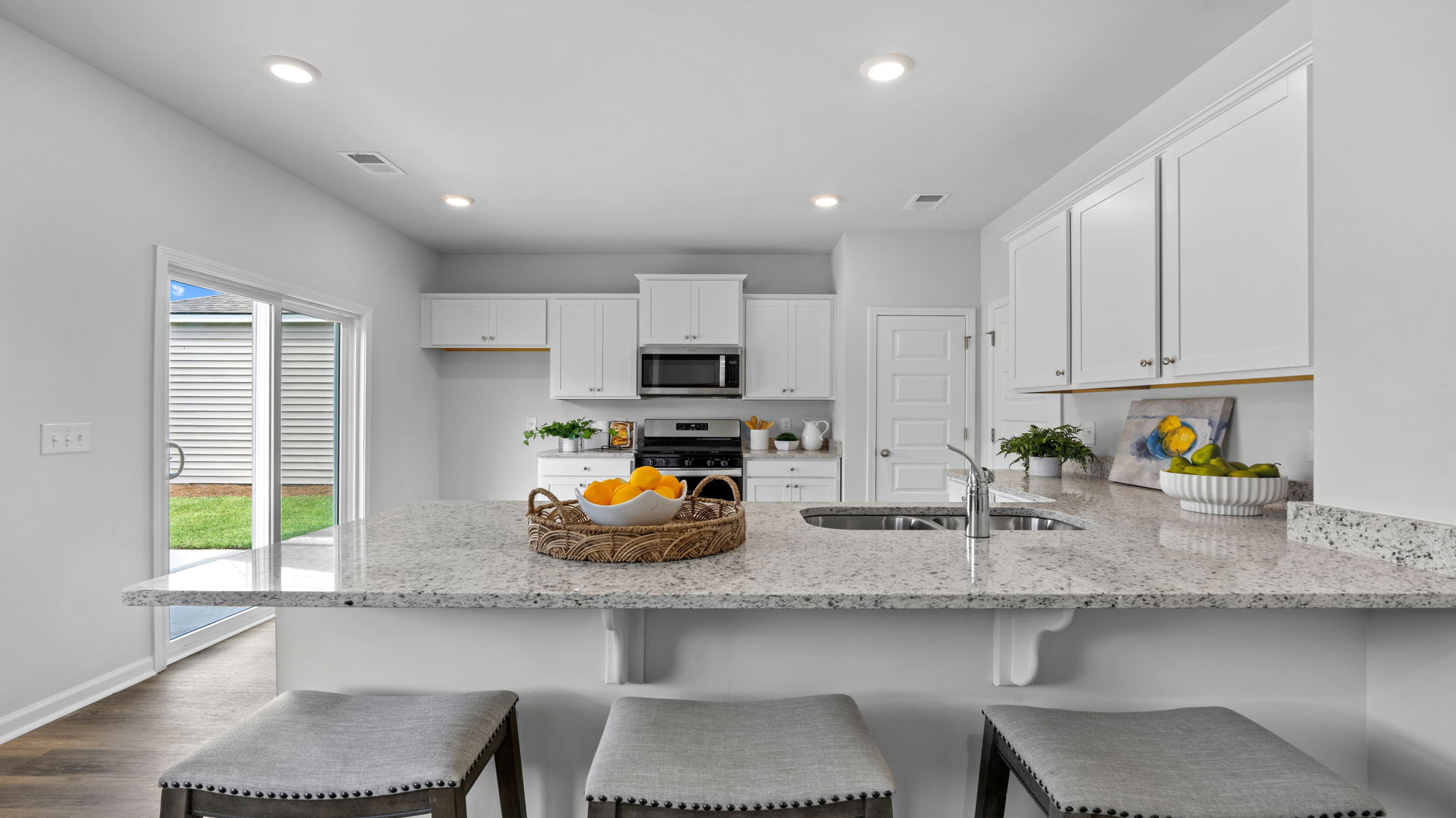 Kitchen with breakfast bar and open view into the living area