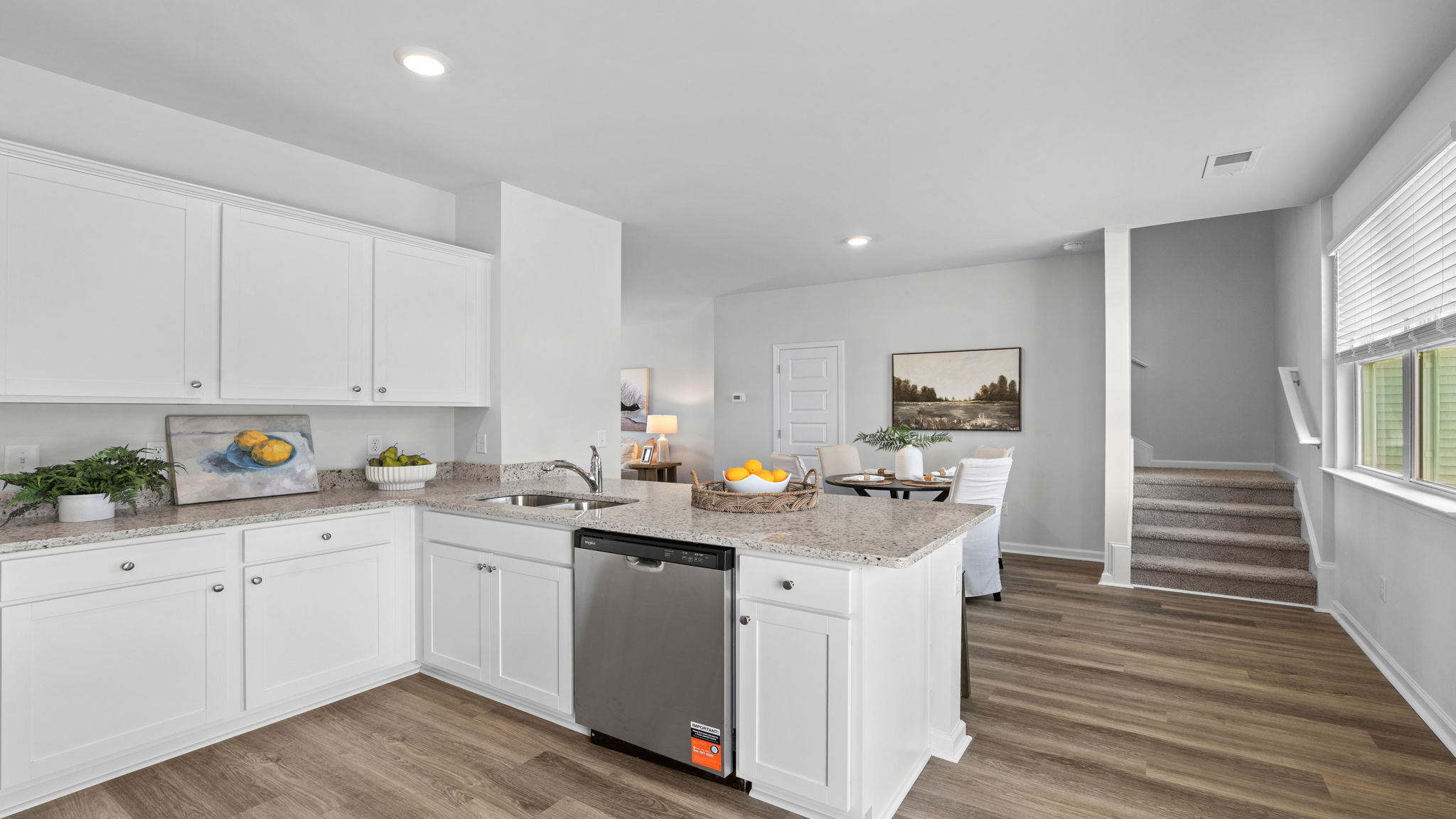 Open-concept kitchen with center island and adjoining living space