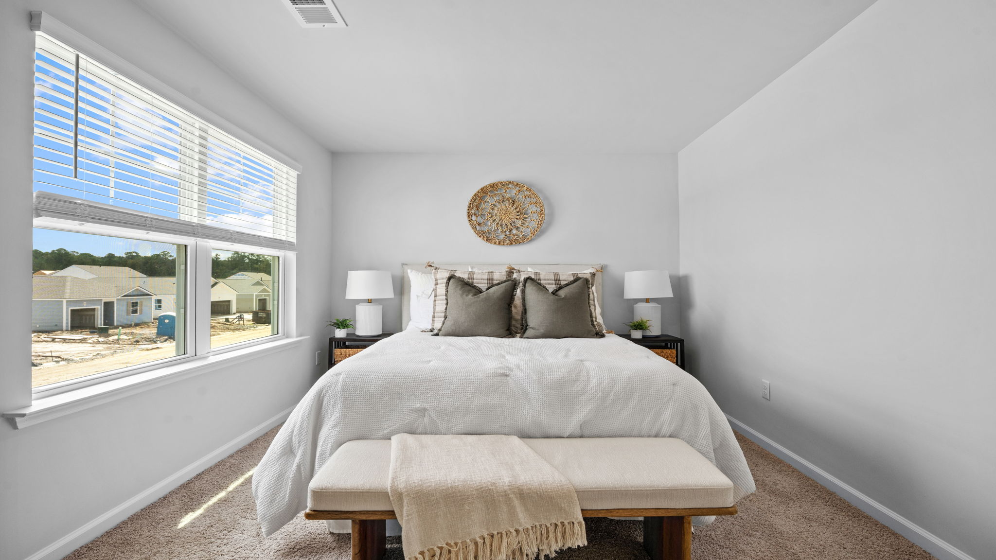 Guest bedroom with large windows and natural light