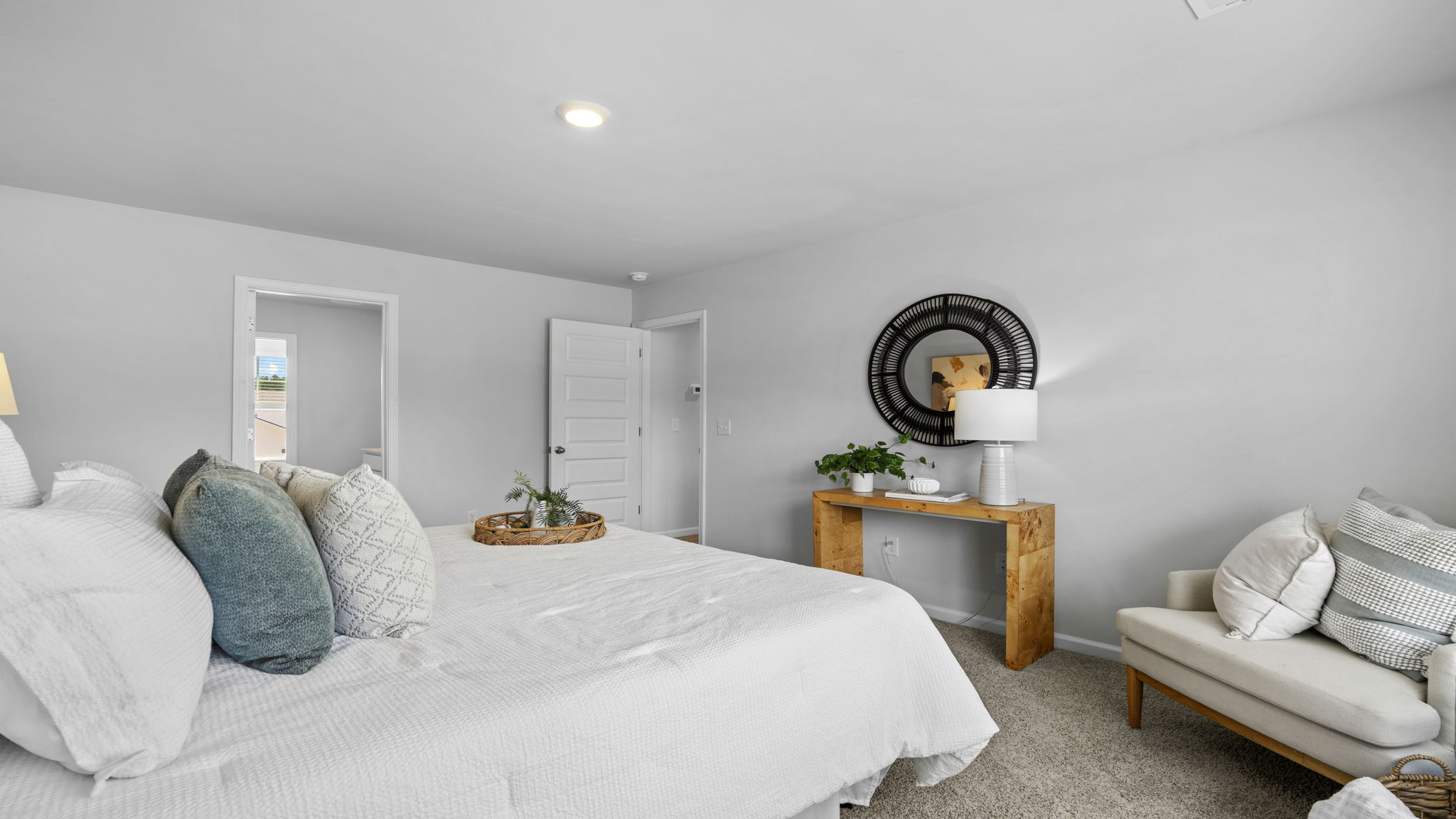 Primary bedroom with sitting area and natural light