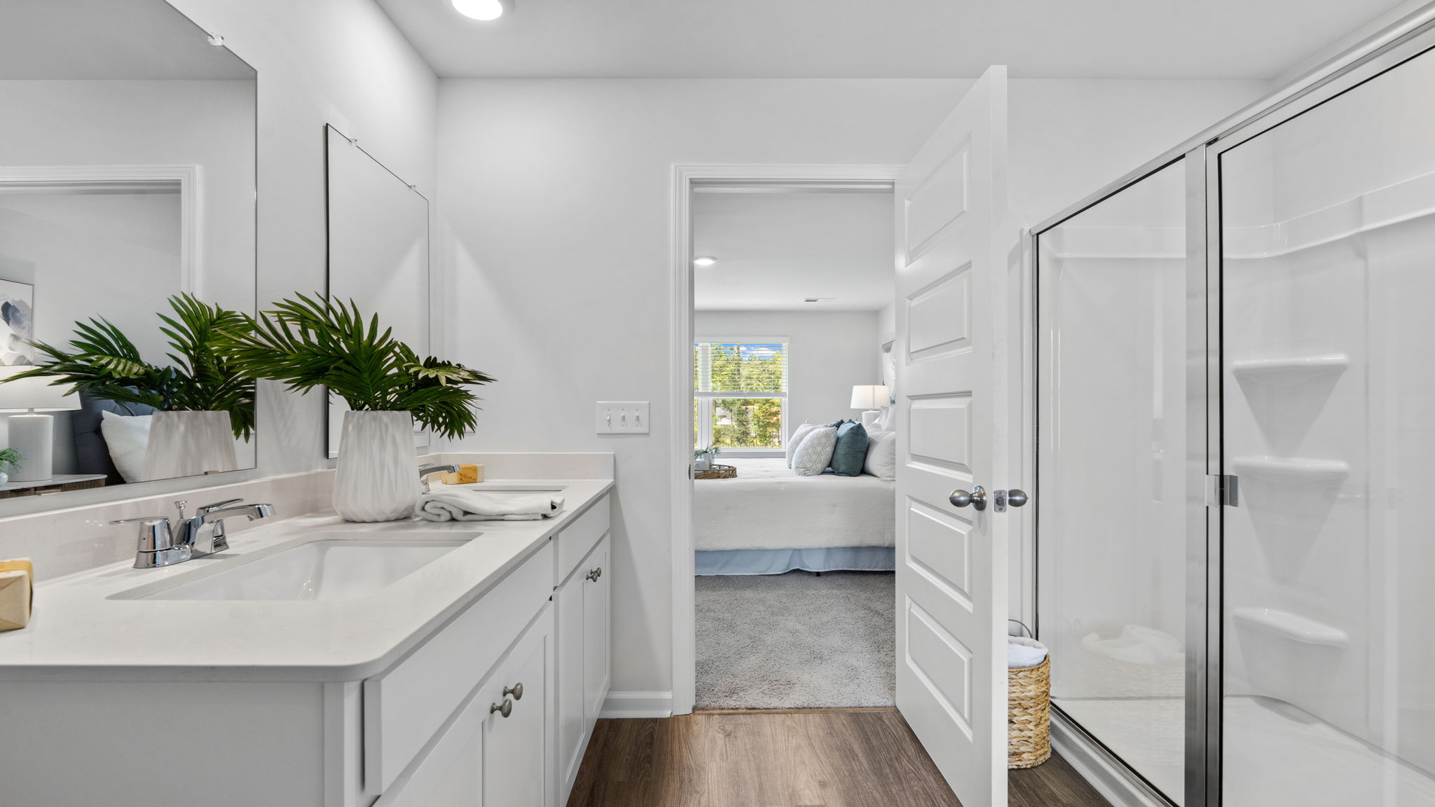 Bathroom with double-sink vanity and bright white cabinetry