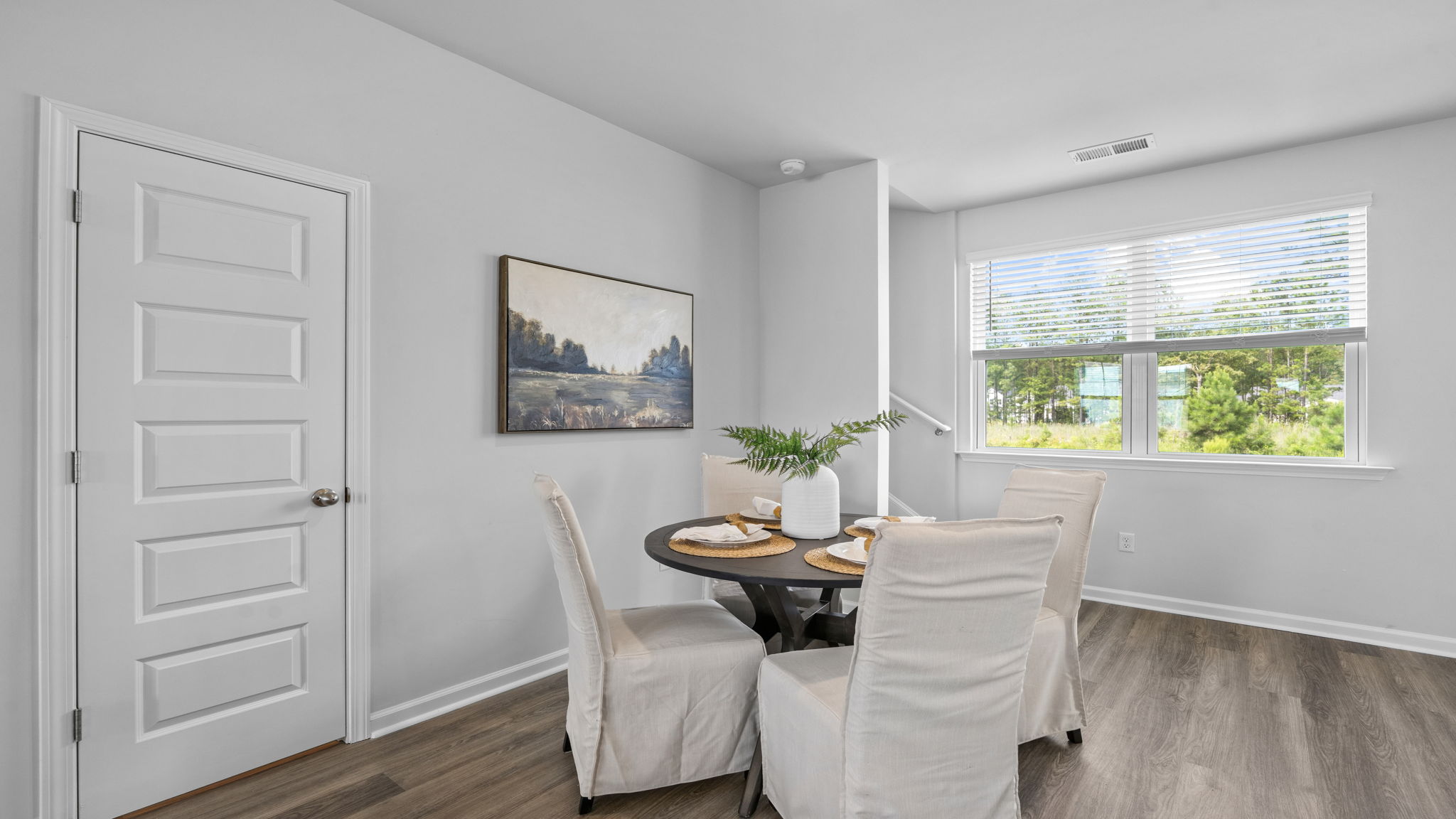 Home entryway with interior doors and wood-look flooring