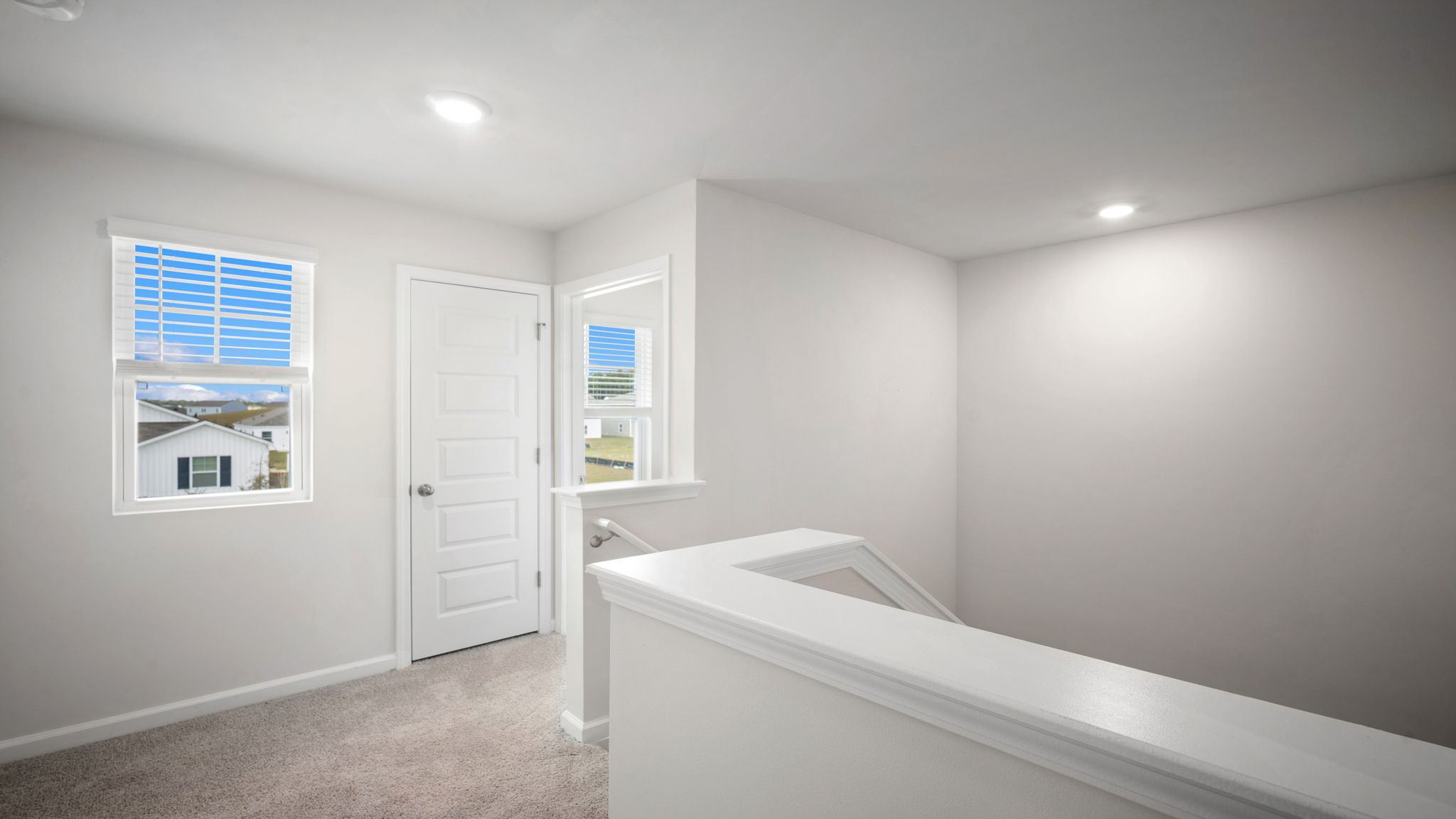 Upstairs loft area with hallway to bedrooms.