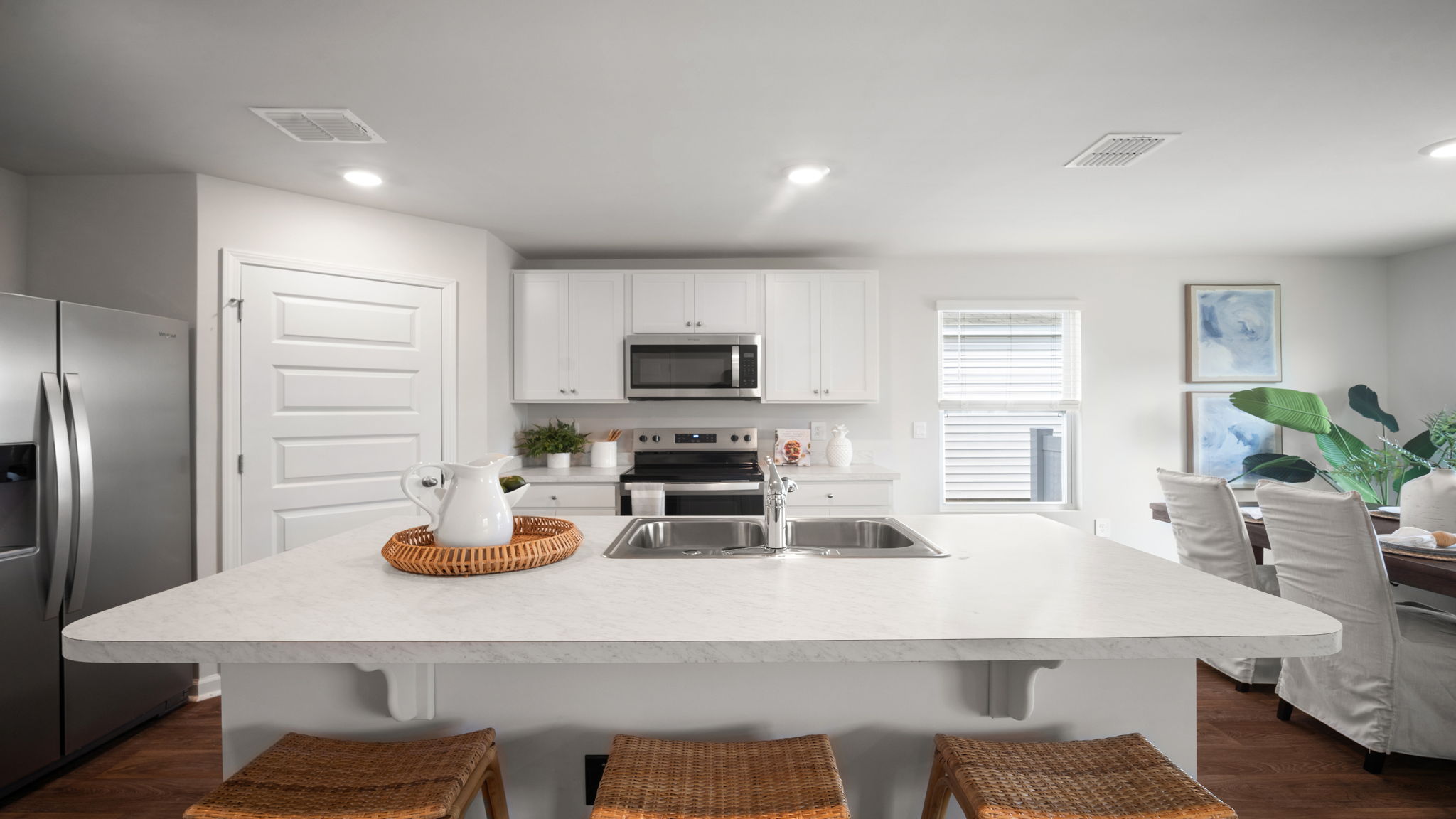 .Large kitchen area with granite countertops, large island, cabinets, tile backsplash, and stainless steel appliances