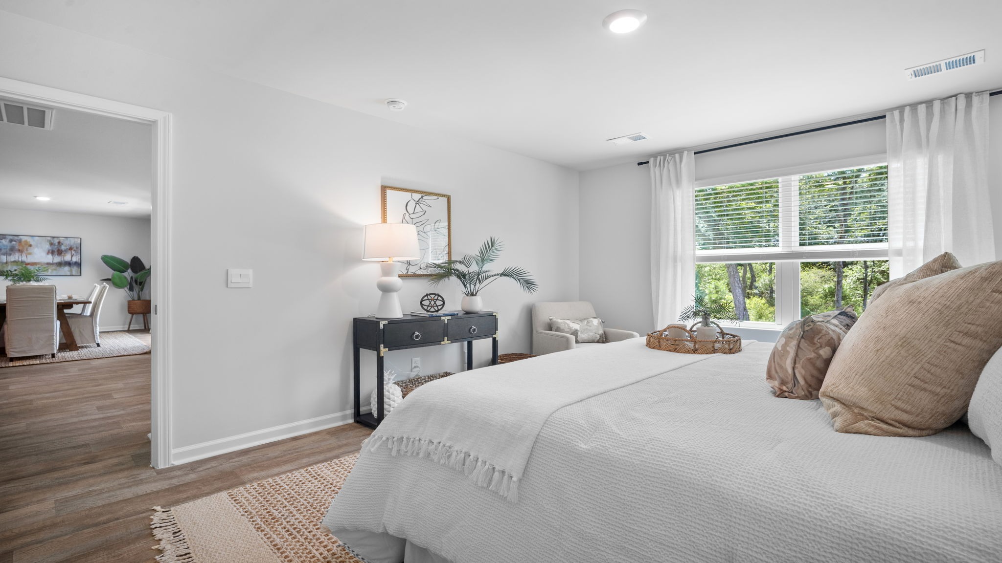 Primary bedroom decorated with a bed and side table