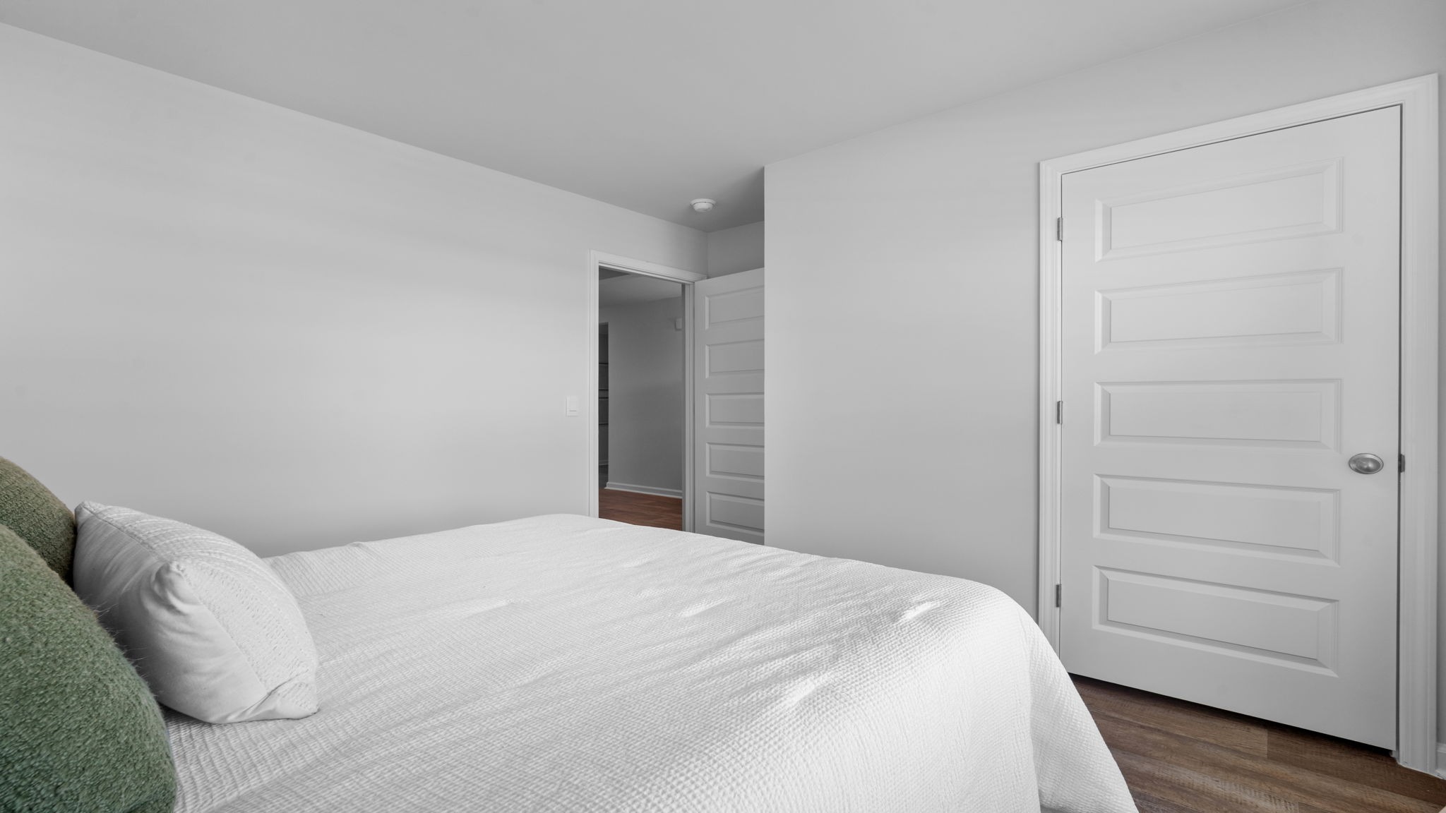 Bedroom with closet door and entry door.