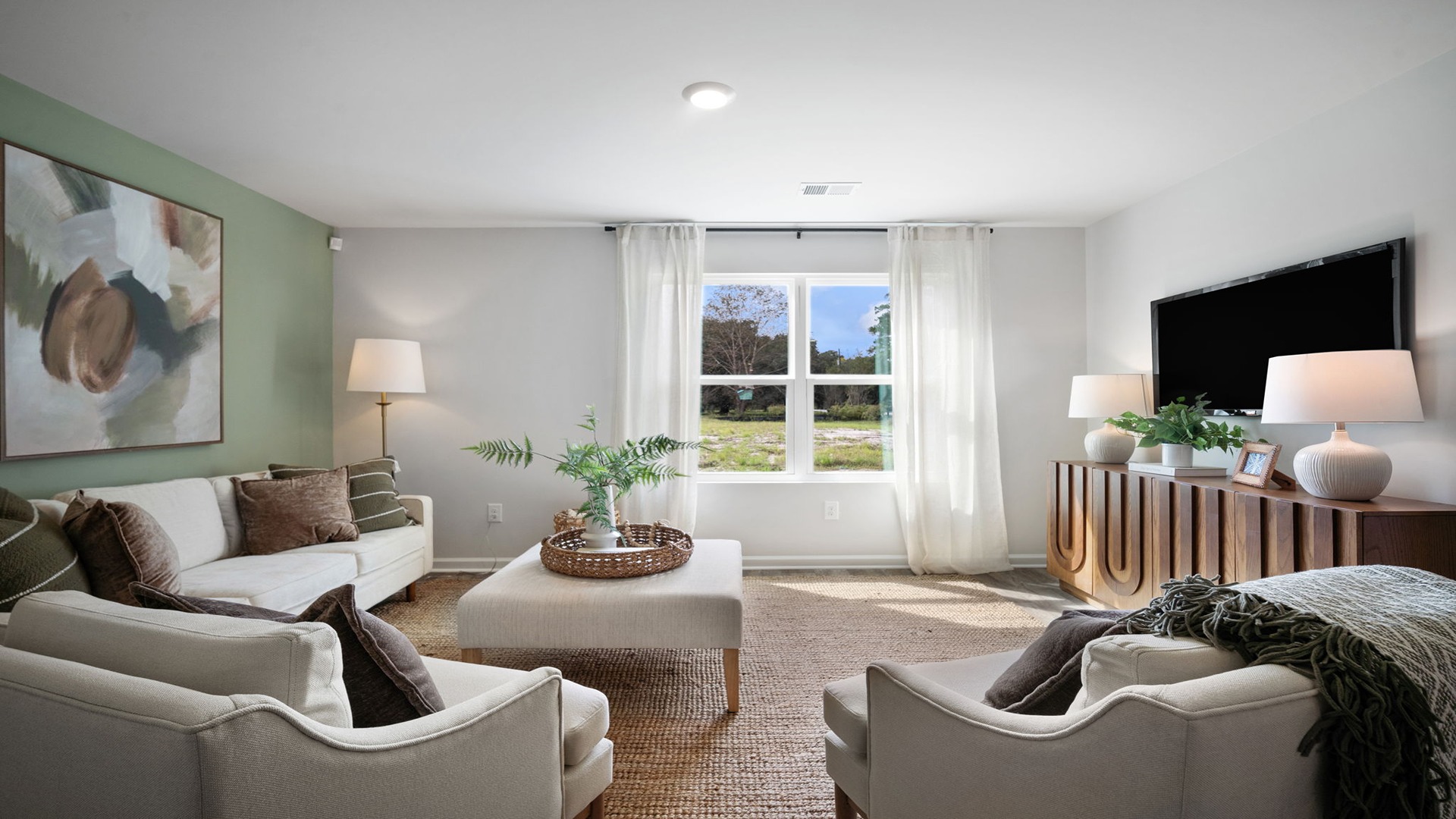 Spacious living area with large windows for natural lighting.