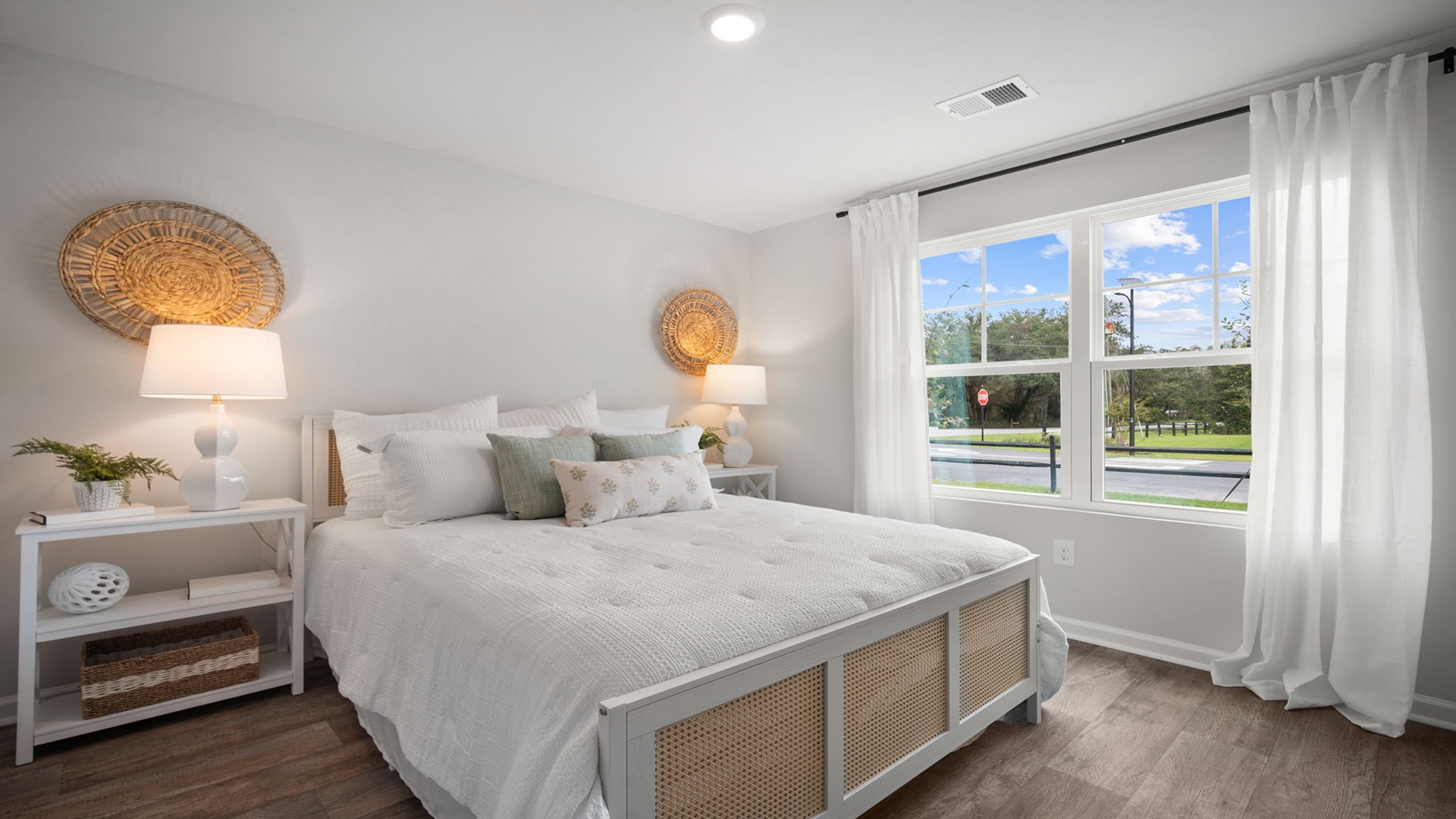 Bedroom with hardwood floors and large single window for natural light.