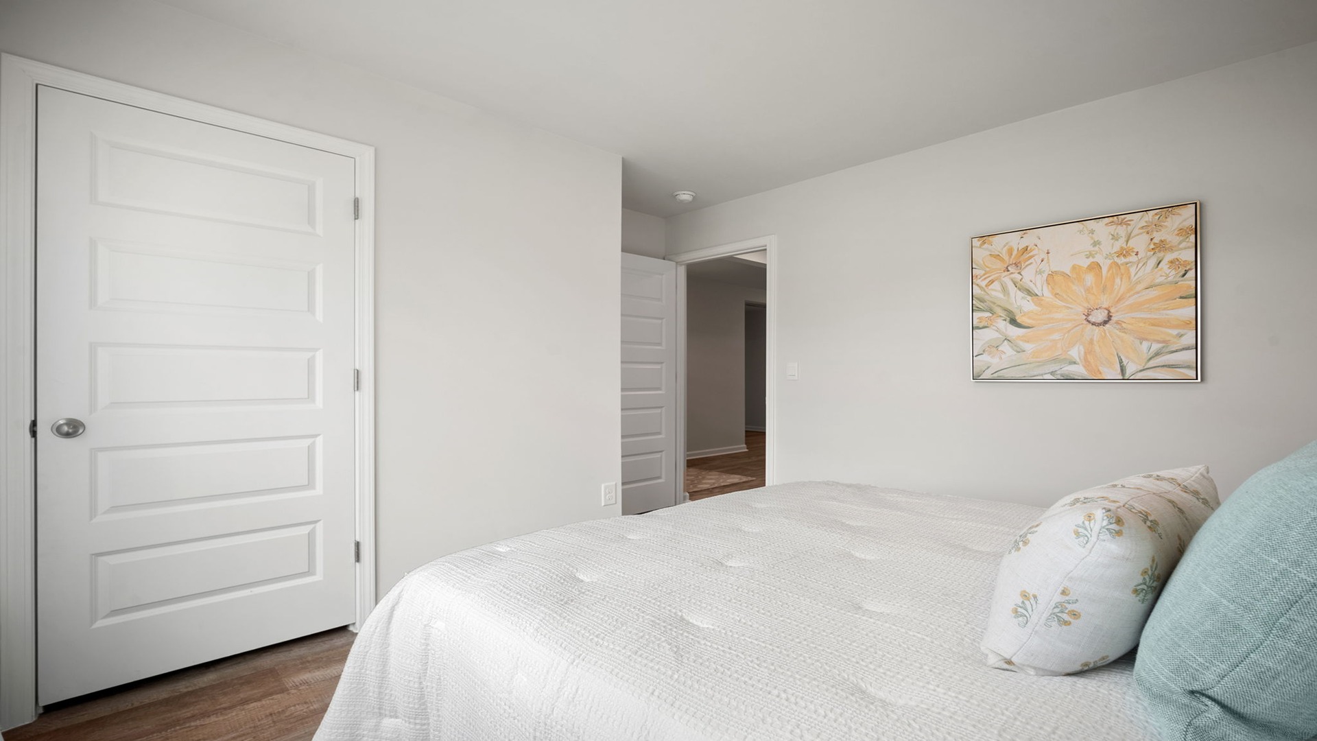 Bedroom with closet door and entry door.