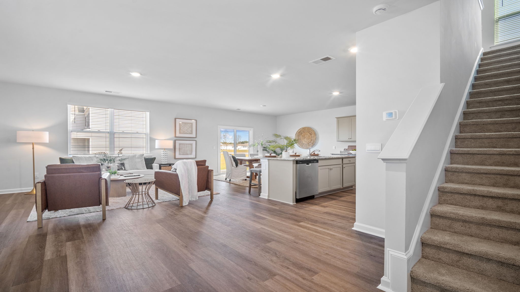 Foyer view of the staircase with a view of the living area