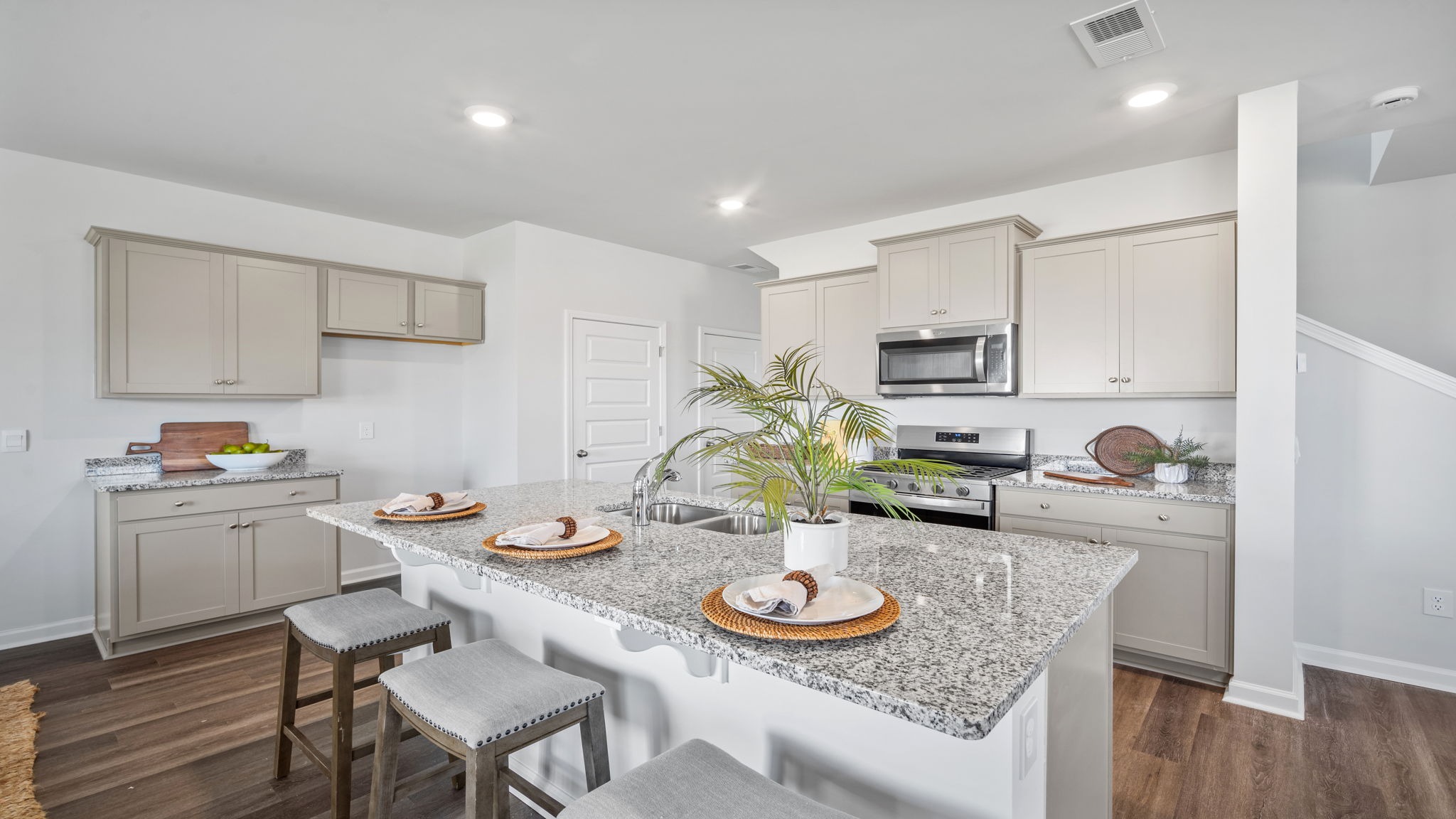 Kitchen island with a view of the oven range in the background
